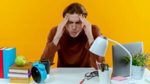 دانشجویی که در حال تلاش برای تمرکز روی درس است اما دچار حواسپرتی شده، نمونهای از چالش تنظیم توجه در اختلال ADHD